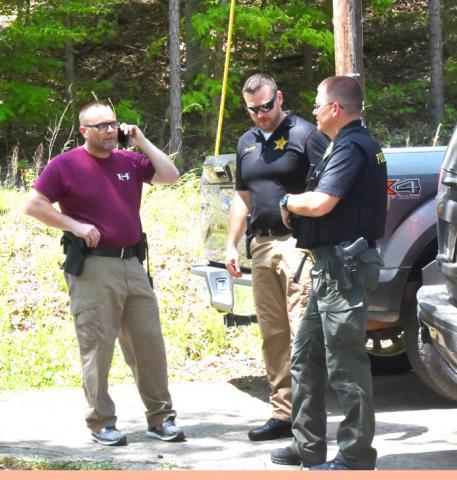Shown helping secure the scene at a double homicide in northern Fayette County on May 1 are, from left: deputies Eric Dubielak and Chad Aldridge of the Fayette County Sheriff Office with Officer Randall Kelley of the Berry Police Department.