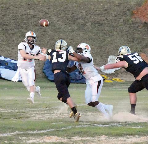 Carter Sanford (17) completes a pass for Fayette as Jason Robinson (2) blocks.