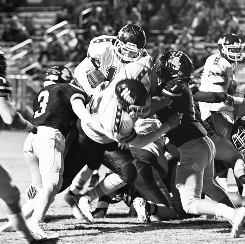 Zach Tidwell (73) blocks two players for Gage Alexander (10) who scores a touchdown for the Lions.