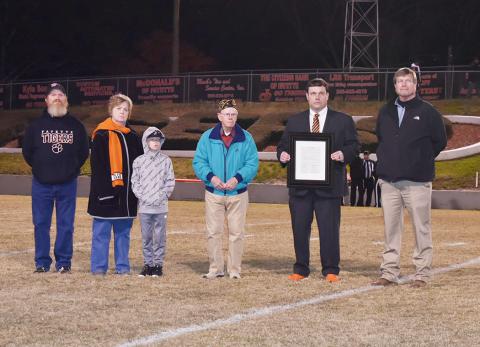 M.C. Younghance was honored prior to the start of the Fayette - Anniston football game for his 44 years of service raising the U.S. flag at all the home football games. Shown from left: Steve Younghance, Sharon Younghance, John Daniel Younghance, M.C. Younhance, FCHS Principlal Dr. Jeremy Madden and Fayette County Superintendent of Education Jim Burkhalter.