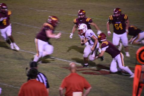 Lake Norris (0) shown here rushing the ball past the Stallions' defensive players | Photo by Kelly Bonner