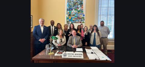 Pictured (L to R): Mayor Rod Northam, Floyd Rodgers, Tracy Hollingsworth, Emily Montague, Priscilla Gray, Shavonne Eatmon, Toni Cook, Robin Hayes, Belinda Langley Watts, Kari DeLoe, and David Allen. Seated: Apryl Smith, and State Treasurer Young Boozer. 