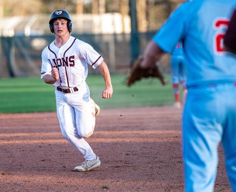 Hub’s Landon Dodd scoring the winning run against Pickens Academy. | Photo by Leah Hollingsworth