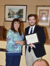 Linda Black, vice-president of the Fayette Garden Club, is shown presenting the Community Service Award to Mason Aldridge.