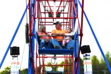 Scott and Charlene Shepherd of Berry are shown enjoying a relaxing Ferris Wheel ride at the Berry Heritage Festival with their two-year old granddaughter, Sadie Howton.