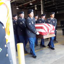 The remains of Sgt. Julius McKinney are shown being carefully carried off the plane after it landed at Memphis International Airport last week. 