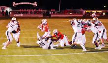 Zack Ingle (14) is shown running for a first quarter touchdown against Winfield as Isiah Dixon (52), Jaylen Hammonds (8) and Coulter Ary (57) block.