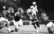 KyHeim Montford (3) runs for a good gain after taking a handoff from quarterback Blake Wallace (4).