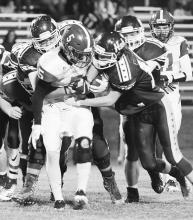 Cannon Alexander (55) has the player wrapped up as Gage Alexander (10) comes in to assist on the tackle.