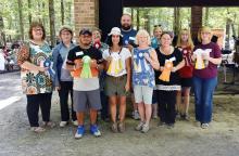 From left, front: Avery Dove, Artists Choice; G. Noelle, Third Place Craft Division; Pam Fikes, First Place Fine Arts Division; and Judy Scott, Patron’s Choice Award. Back: Karen Thompson, First Place Folk Art Division; Dana Burkett, Third Place Folk Art Division; Patti Butler, Second Place Craft Division; Shane Harkness, First Place Craft Division; Jackie McQueen (accepting for Nell Chapman), Best of Show; Stephanie Drew, Second Place Fine Arts Division; and Jenny McBride, Third Place Fine Arts Division.