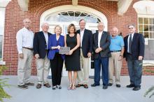 Pictured with the plaque designating the John Clifford Grimsley House as a site on the National Register of Historic Places are members of the Fayette Historic Preservation Commission and members of the Grimsley family. Shown from left: Fayette City Councilman Eddy Campbell, Tom Matkov, Becky Matkov, Liz Venable, Scott Venable, Fayette Mayor Ray Nelson, Preservation Commission Member Ben Hightower and Preservation Commission Member Dale Lawrence.