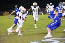 Will Brown (15) is shown running for yardage after catching a pass in the fourth quarter. Also pictured is Jakorey Burris (24) looking for someone to block.