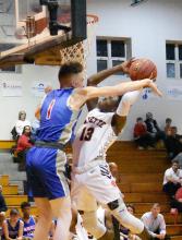 Darius Loyd (13) powers his way to the basket as he is fouled by a Cordova player.