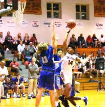 Korey Burris (14) jumps high to score for the Fayette Tigers.