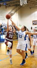 Madison Cribb (20) is shown making a basket for Hubbertville.