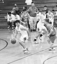 Isaac Darty is shown bringing the ball up the court for the Berry Wildcats.