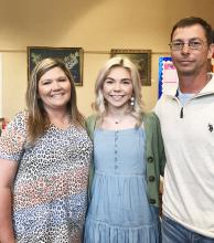 Scholarship recipient Elizabeth Driver (center) is pictured with her parents Misty and Chris Driver.