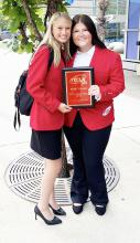 Zoe Whitson (left) and Maci McCaleb pose with the first place plaque they received for Hubbertville’s FCCLA.