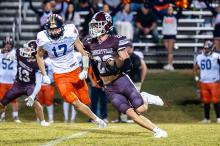 Hub’s Kane Rushing (23) rushes past a Bobcats’ defender. | Photo by Leah Hollingsworth